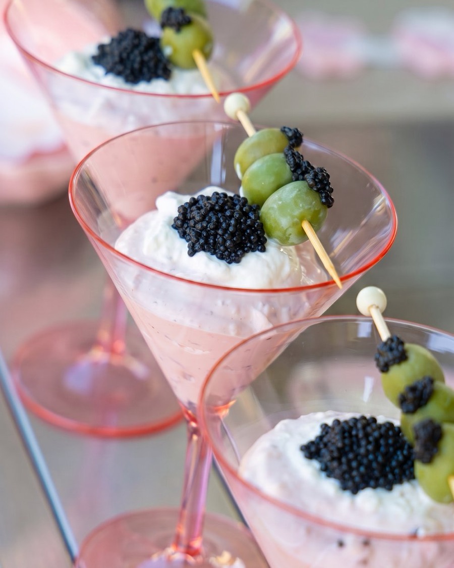 A seasonal LuxeBite: caviar over whipped dip in pink martini glasses